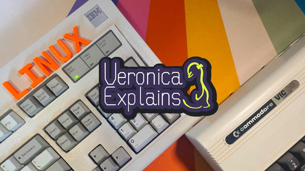 A model M keyboard adorned with orange 3D printed LINUX letters. Below the keyboard is a commodore 64. In front of the technology is the Veronica Explains logo.